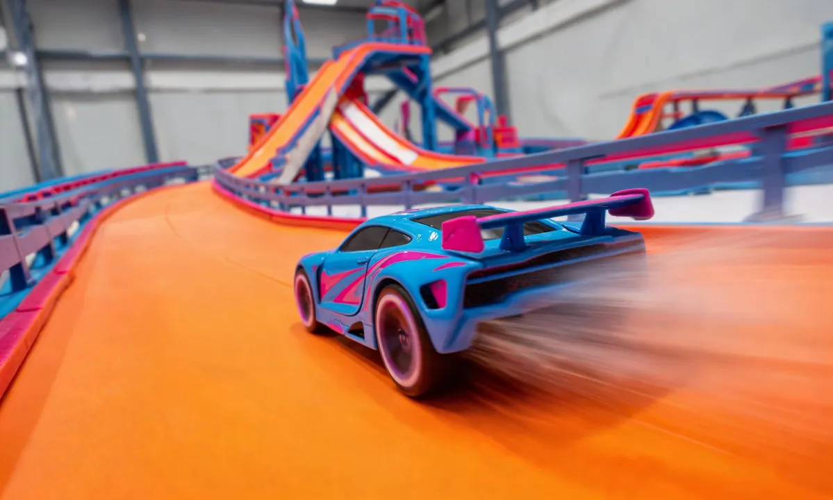 RC car racing across a playroom stunt course